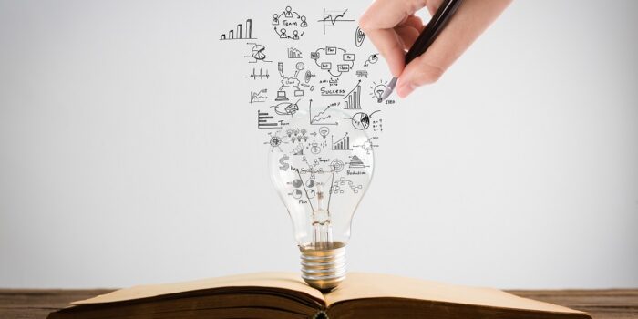 Book and light bulb with hand drawing graph